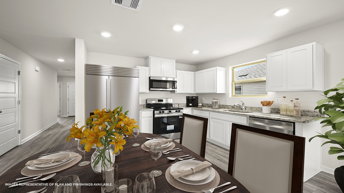 White kitchen cabinets with stainless steel appliances and eat in kitchen space