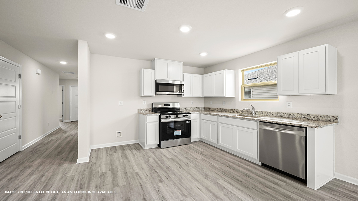 White kitchen cabinets with stainless steel appliances and eat in kitchen space