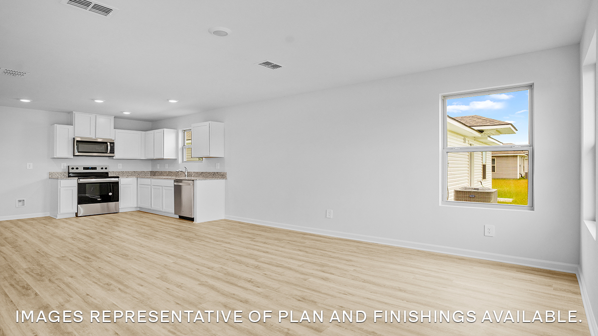 Open-concept living room with dual windows facing front of the home