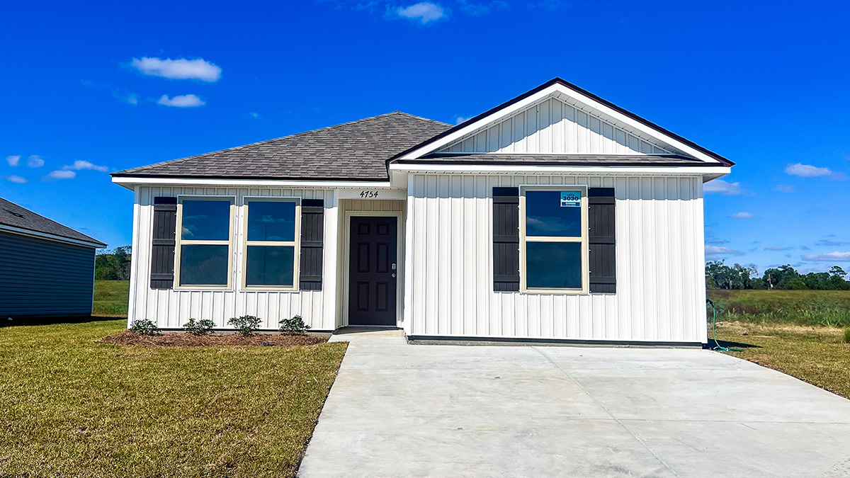 single-story home with white vinyl siding and black front door and shutters and porch