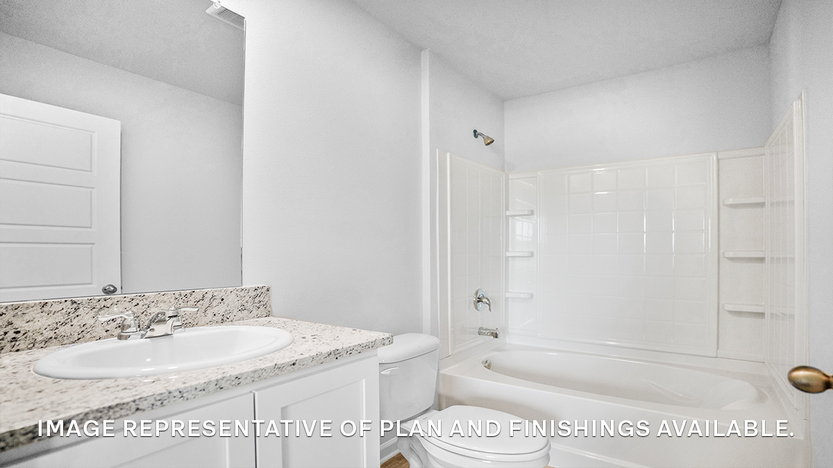 White dual vanities with shower and tub combo and toilet