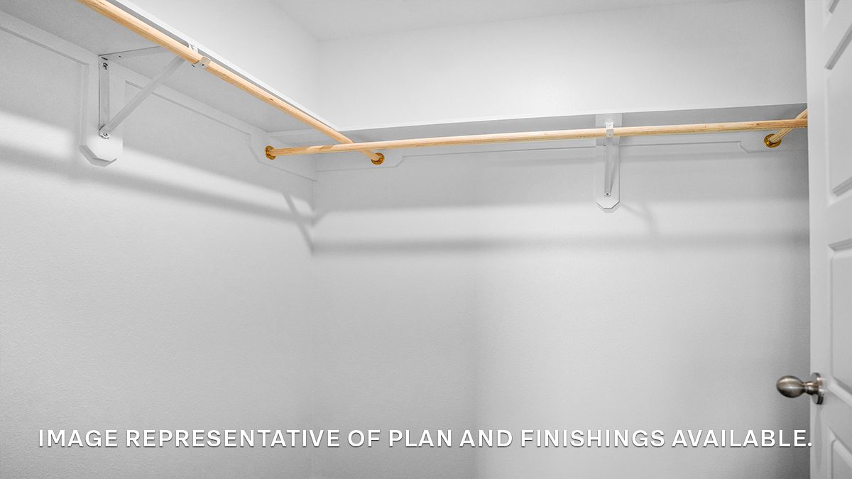 Spacious walk in closet with racks