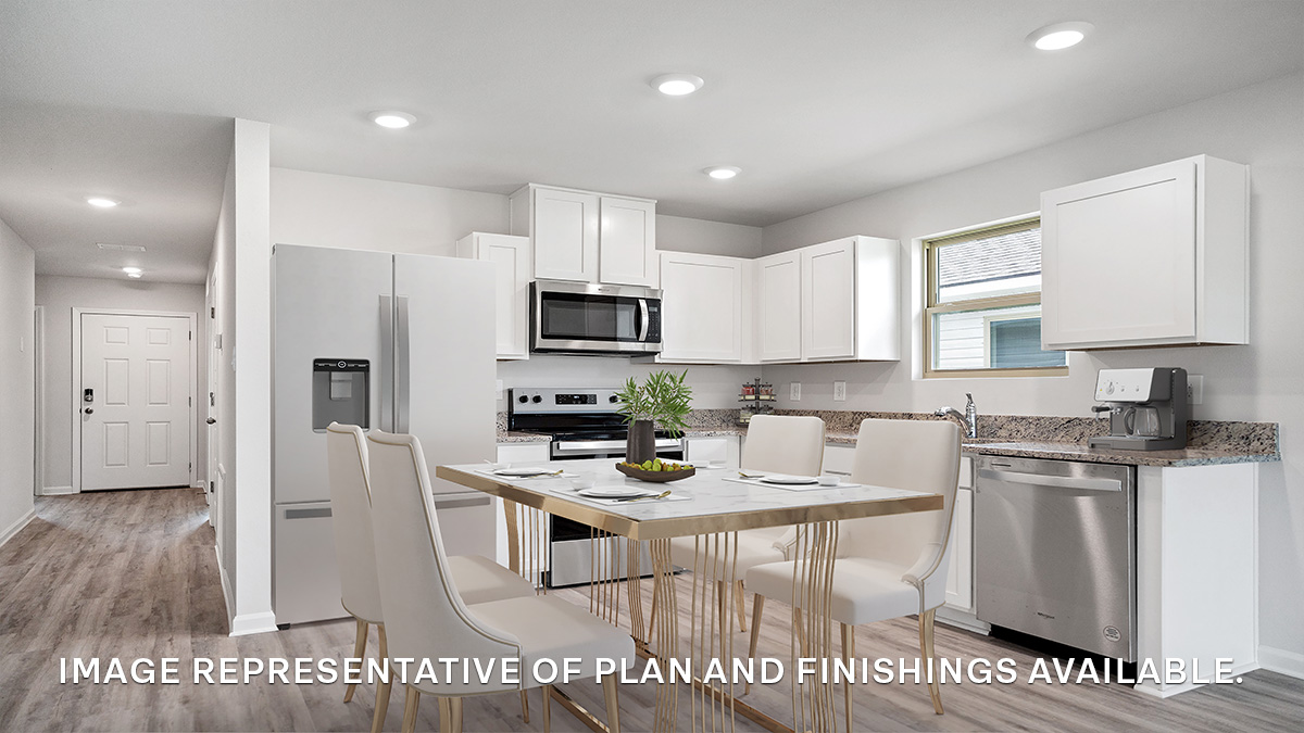 White kitchen cabinets with stainless steel appliances and eat in kitchen space