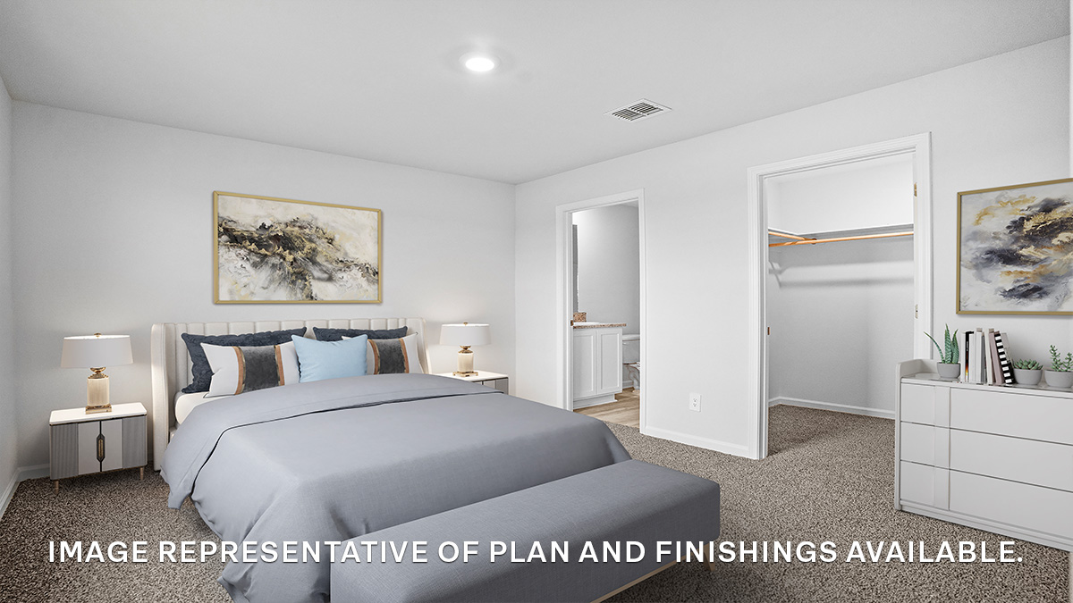 Large primary bedroom with dual windows overlooking the backyard