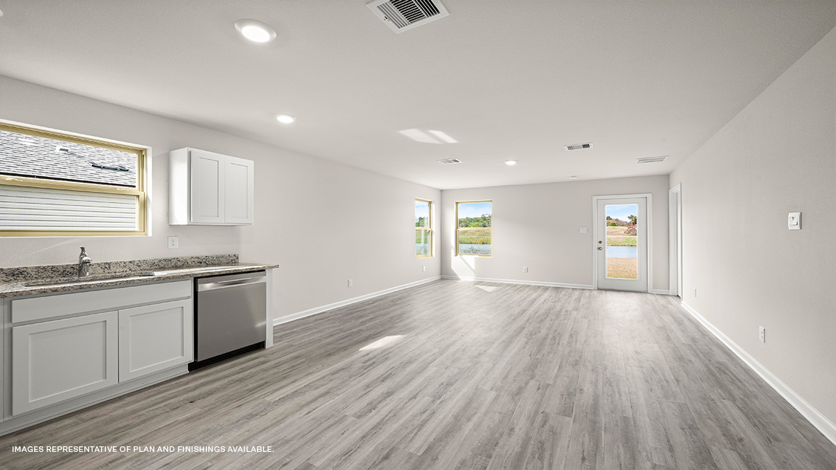 Open-concept living room with dual windows facing front of the home