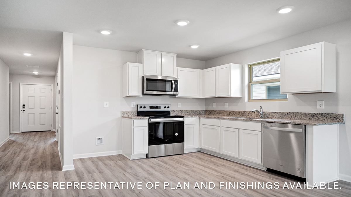 White kitchen cabinety with stainless steel appliances and eat in kitchen space