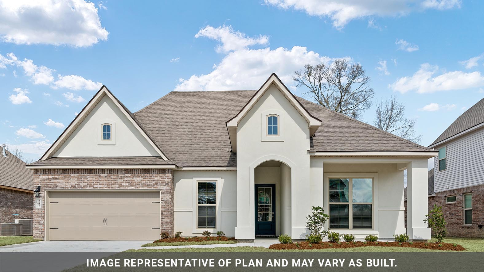 single-story home with tan stucco and brick with two-car garage