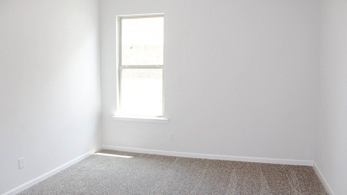 Second bedroom with dual windows and space for queen bedroom set
