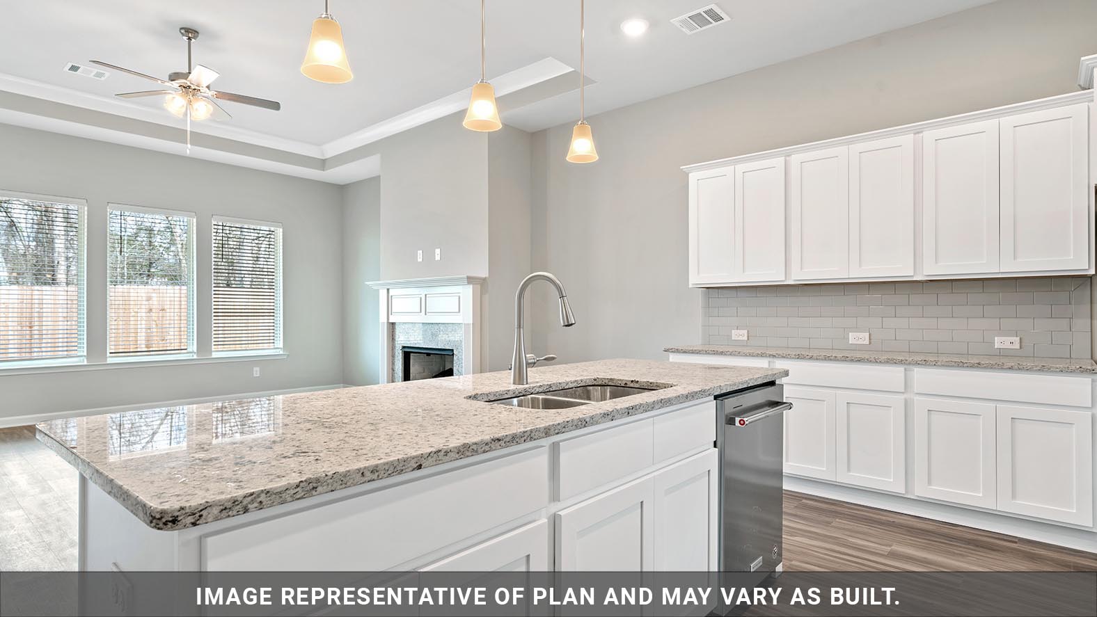 white kitchen cabinets with stainless steel appliances and living room