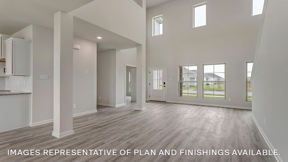 Spacious living room with opening to open-concept kitchen and dining room