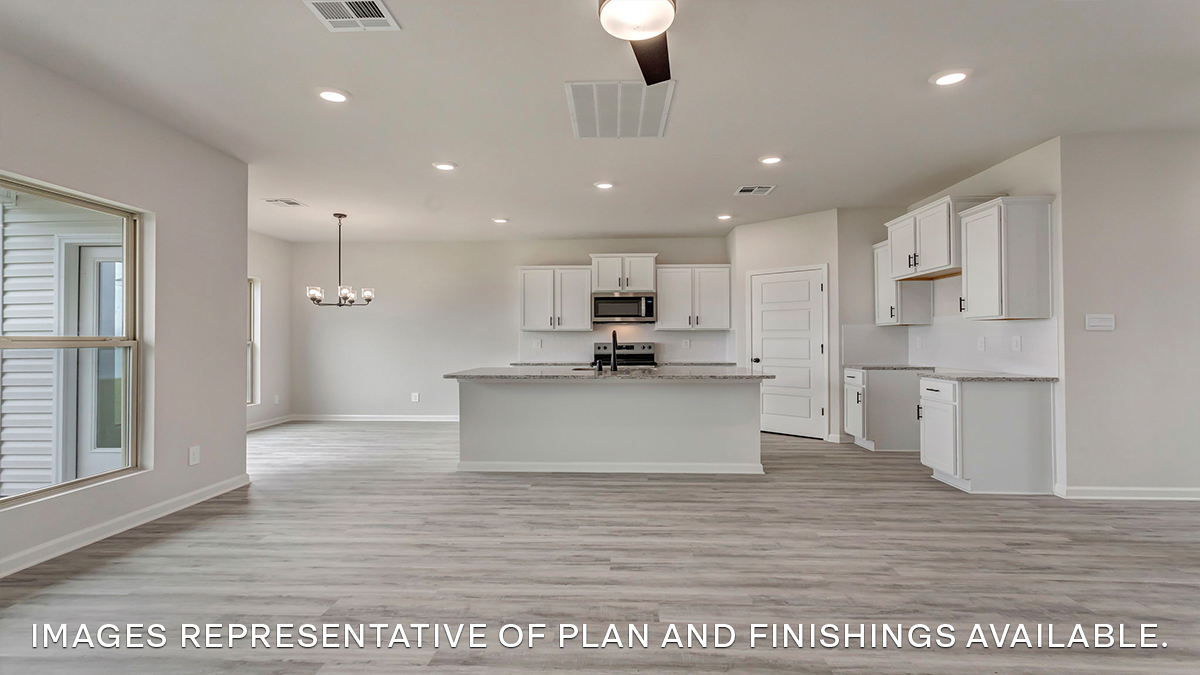 Spacious living room with opening to open-concept kitchen and dining room