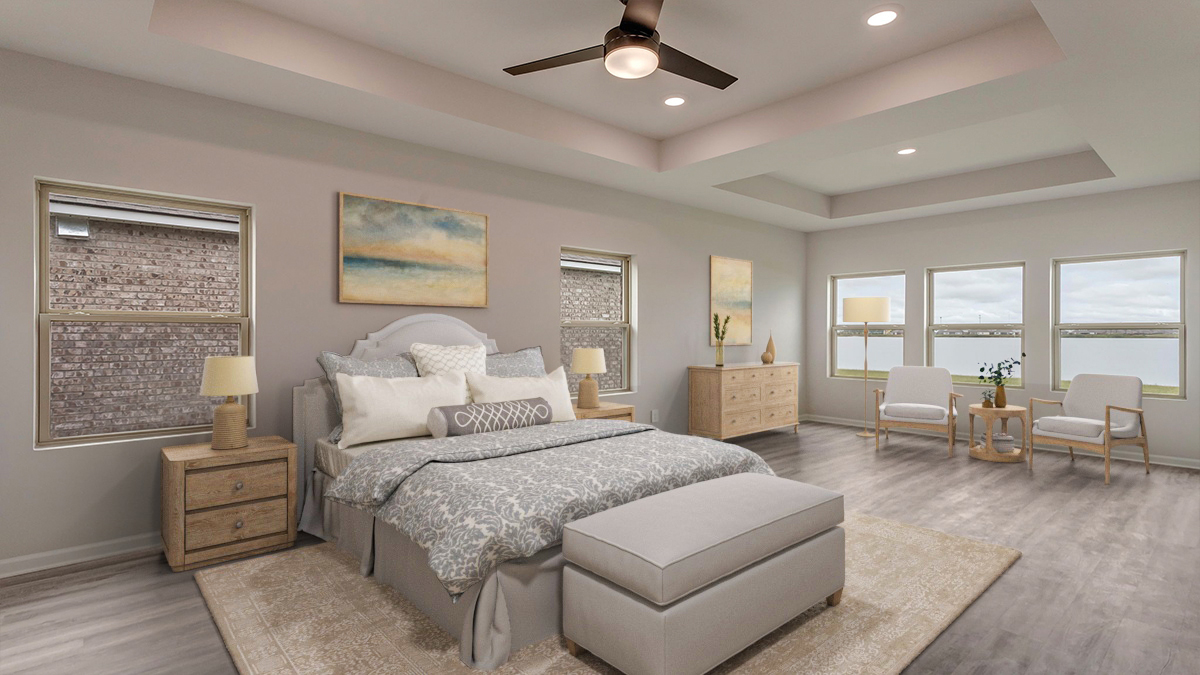 Primary bedroom with trace ceilings and multiple windows