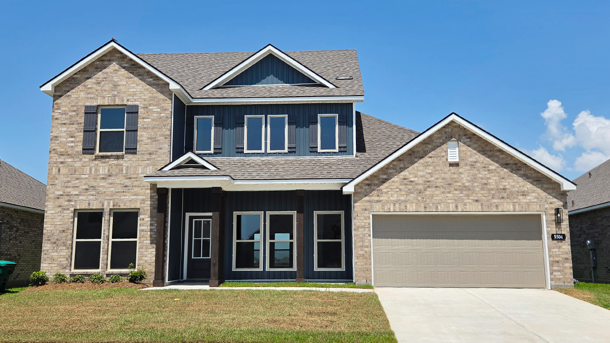 Two-story home with white hardie vinyl and brown brick. Black glass front door with black shutters and white trim.