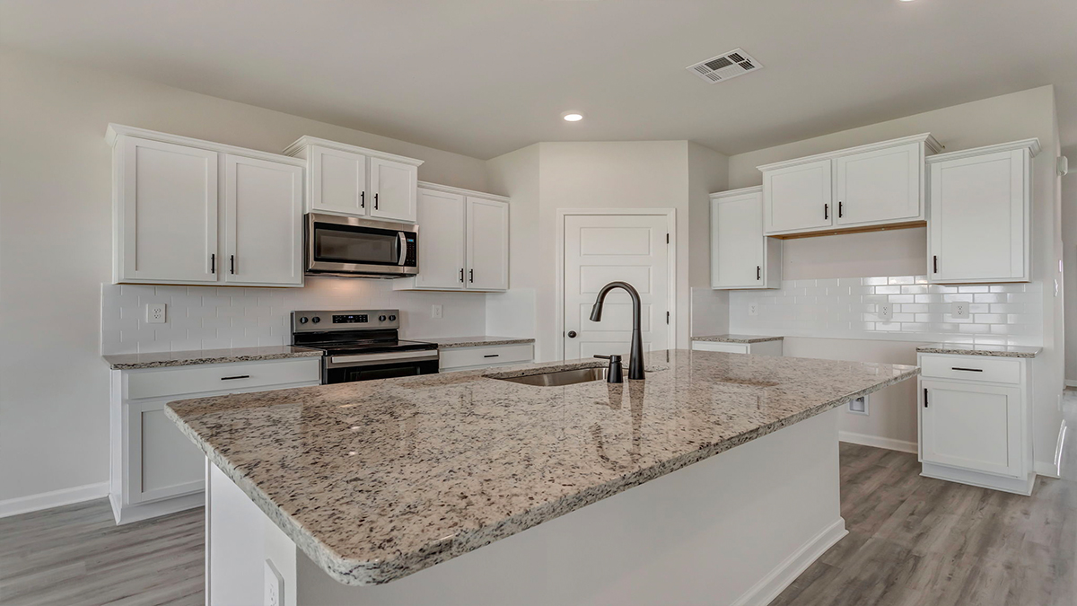 White kitchen island with stainless steel appliances