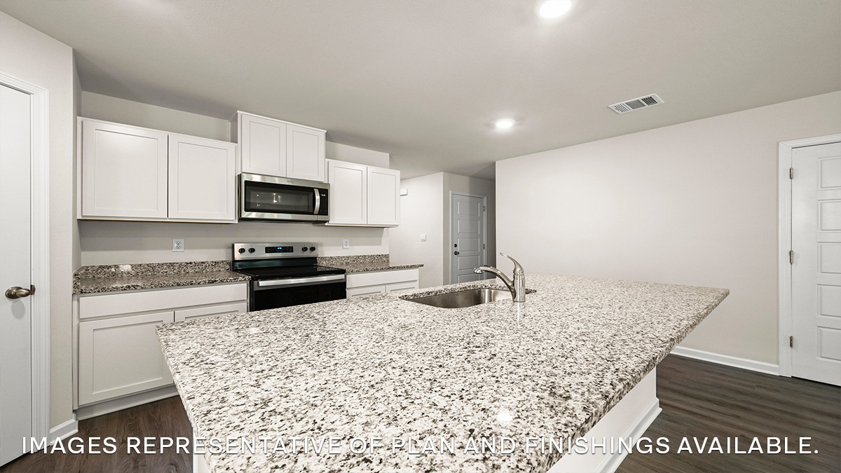 White kitchen island with stainless steel appliances with pantry access