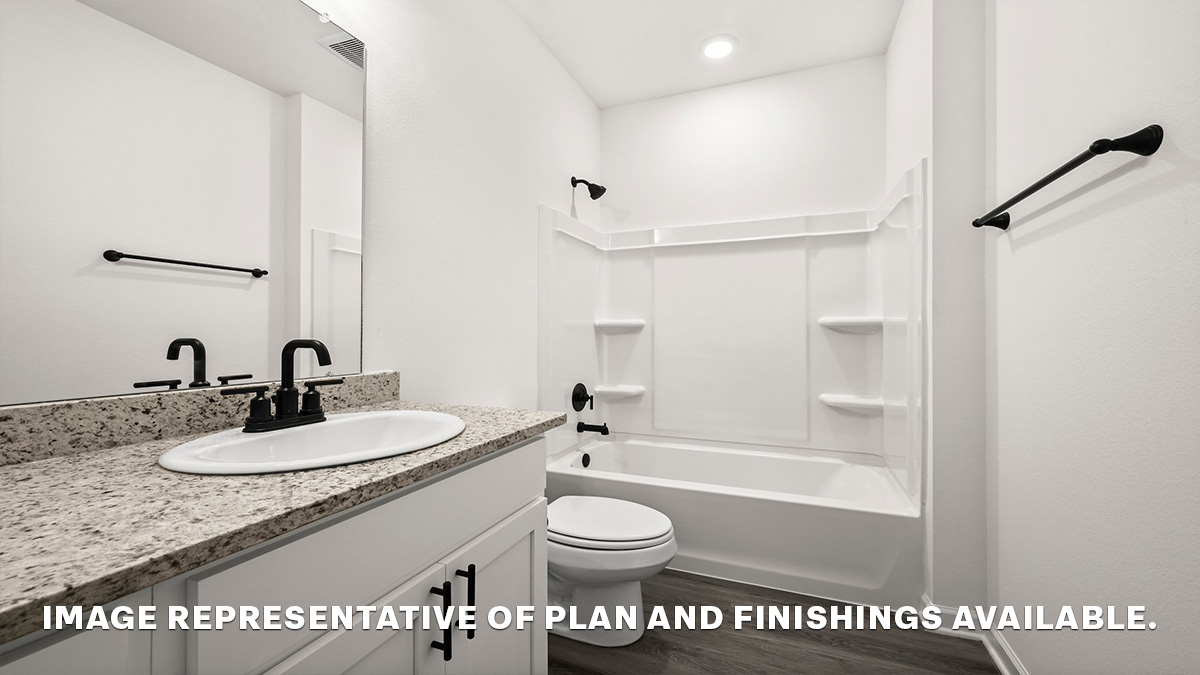 third bathroom with single vanity and shower tub combo and toilet