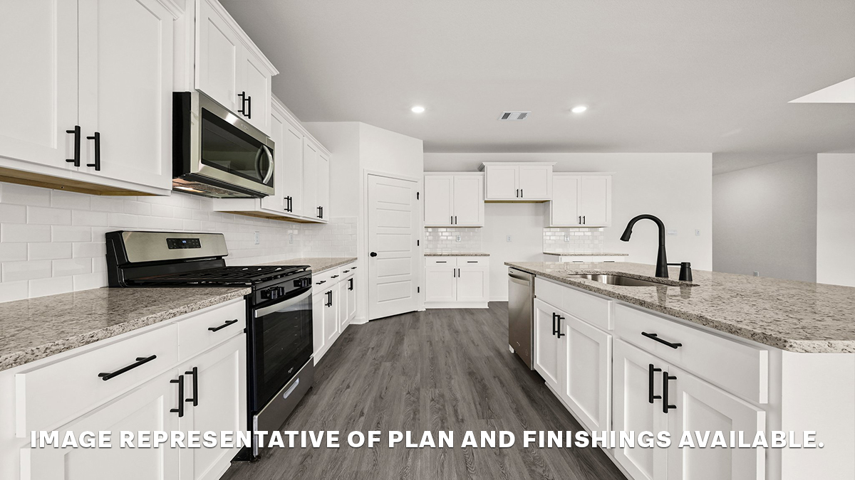 white kitchen island with gray granite and stainless steel appliances
