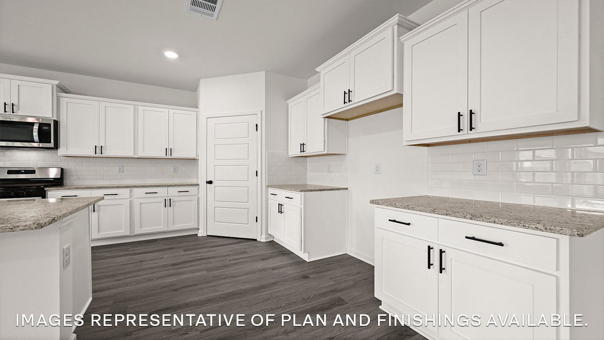 white kitchen island with gray granite and stainless steel appliances and pantry access