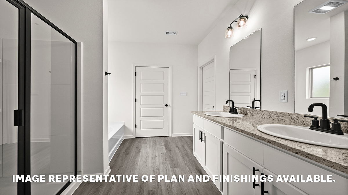 primary bathroom with dual vanity and separate tub and shower