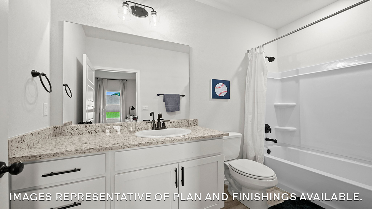 second bathroom with single vanity and shower tub combo and toilet