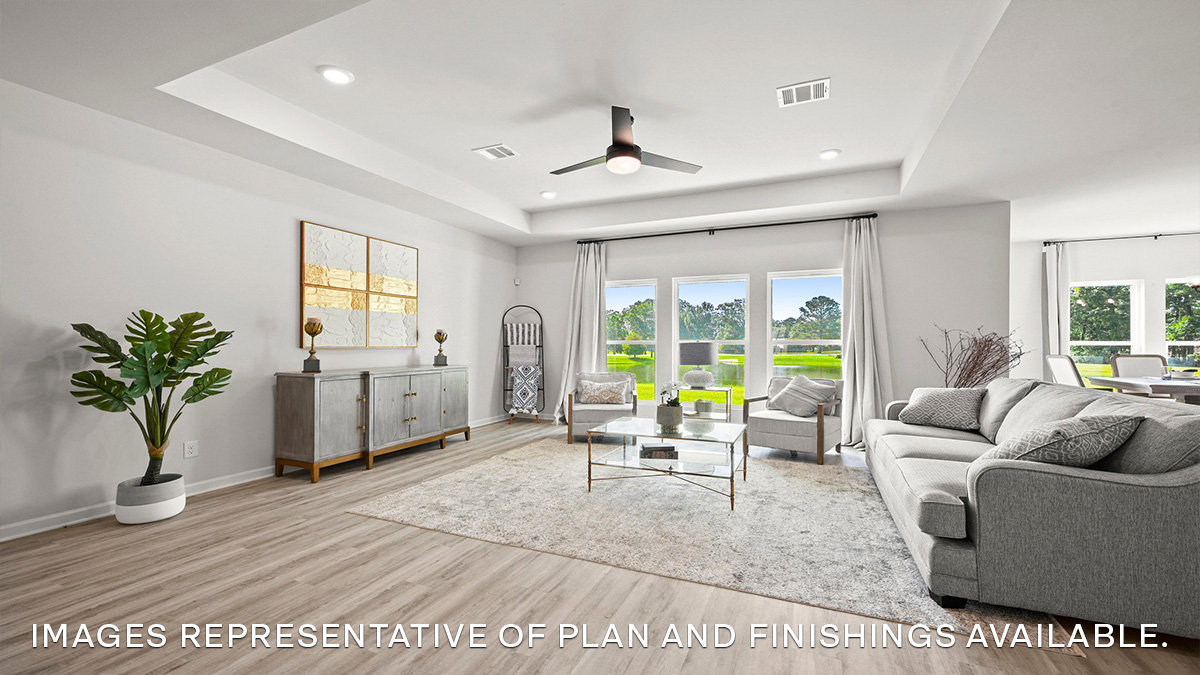 open-concept living room with multiple windows facing the backyard
