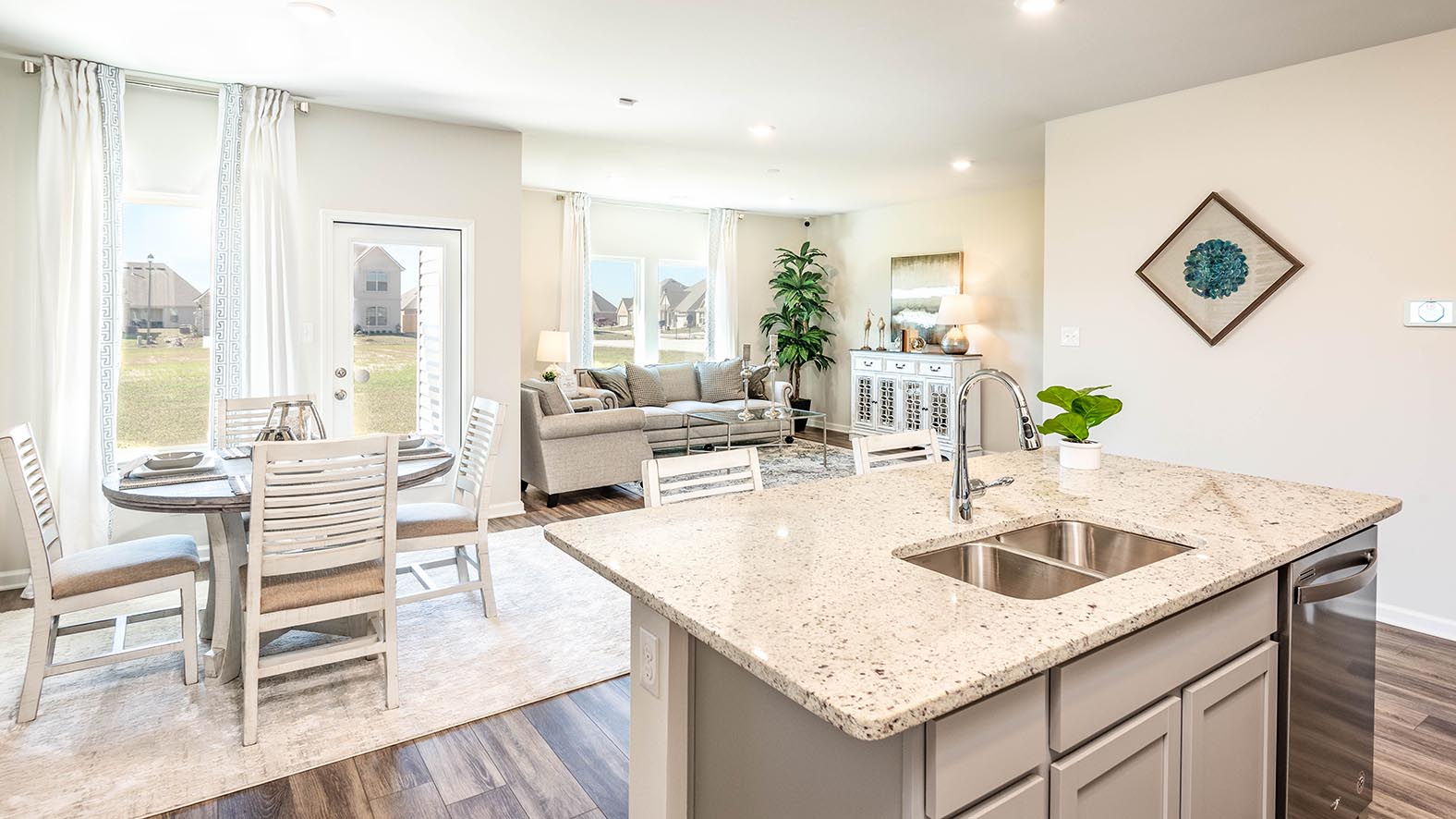 grey kitchen cabinets with stainless steel appliances and pantry access