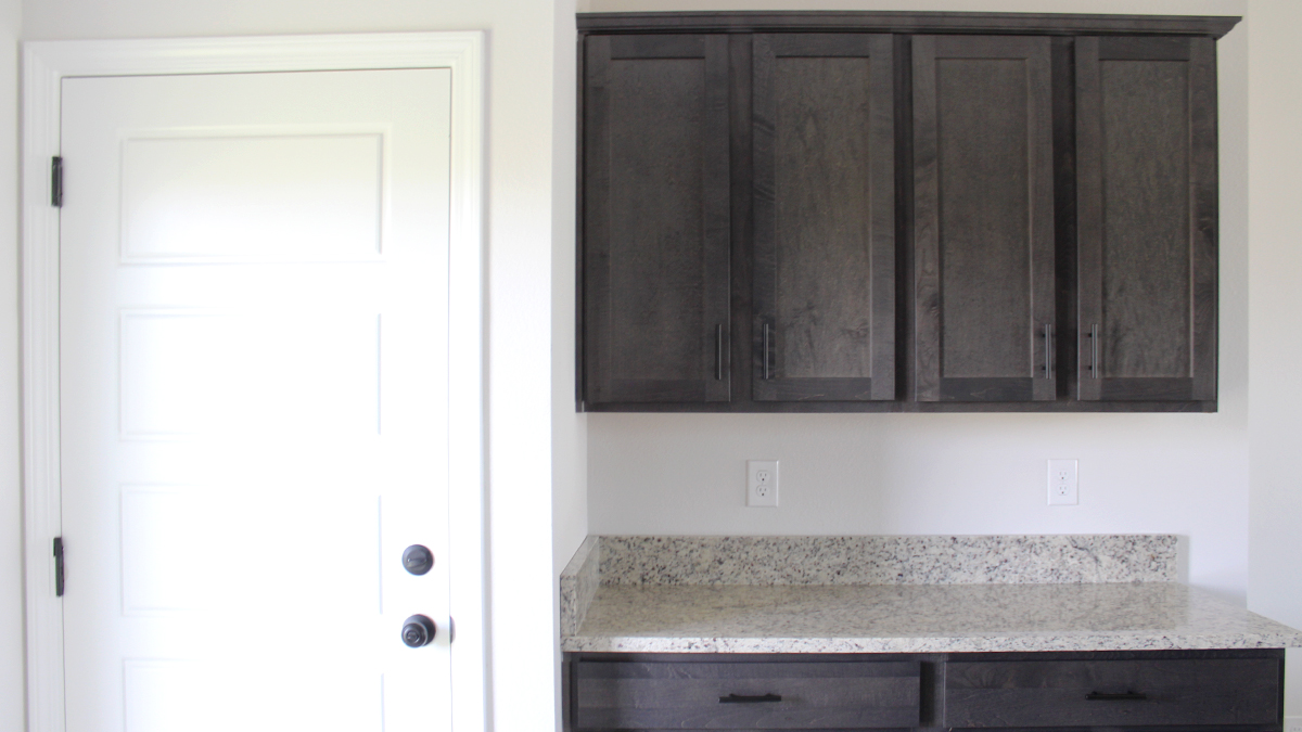 Dark kitchen cabinets with stainless steel appliances and eat in kitchen space