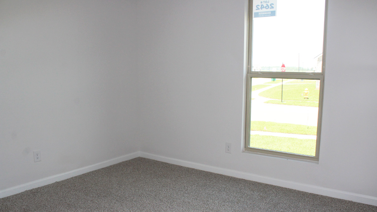 Second bedroom with window and space for queen bedroom set