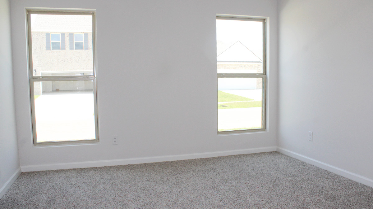 Large primary bedroom with dual windows