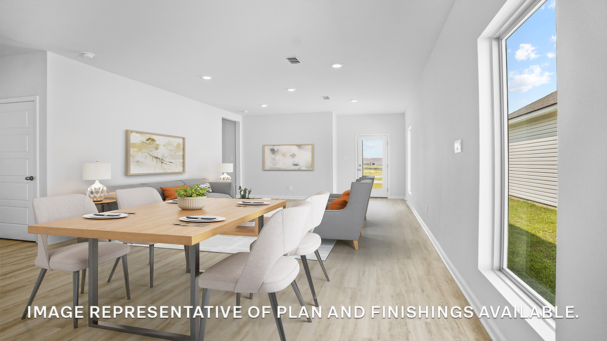 Open-concept living room and dining room with access to backyard