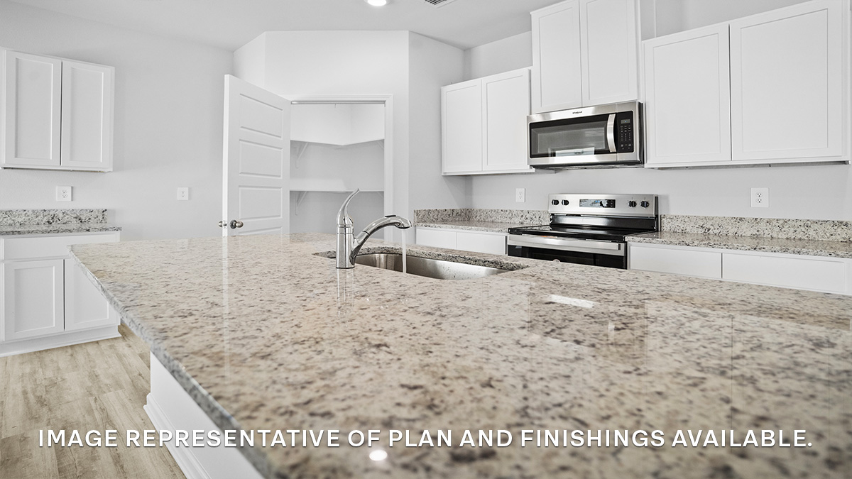 White kitchen island with stainless steel appliances with pantry access