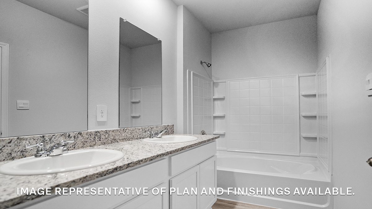 White dual vanities with shower and tub combo and toilet