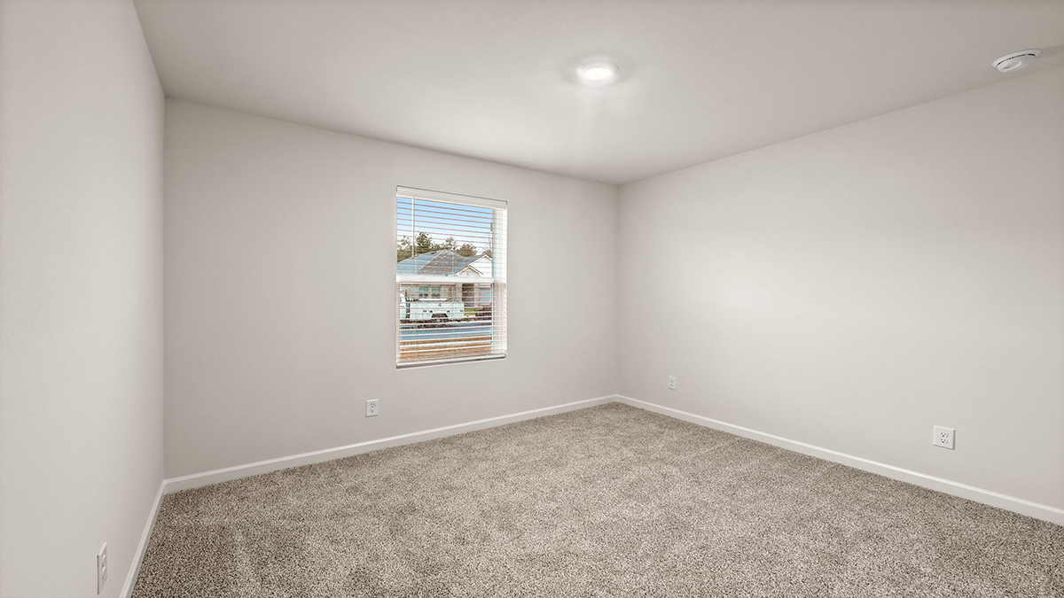 fourth bedroom with single window and room for queen bed