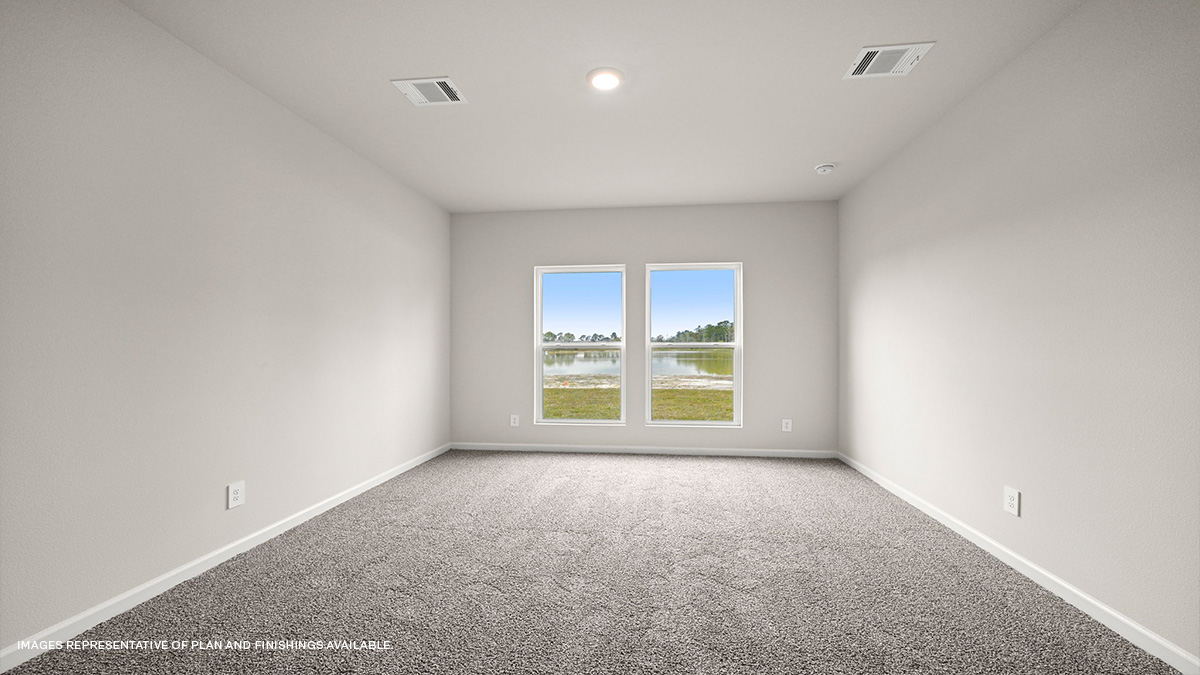 Primary bedroom with dual windows overlooking the backyard