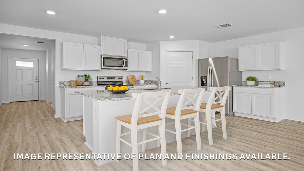 White kitchen island with stainless steel appliances and stools with pantry access