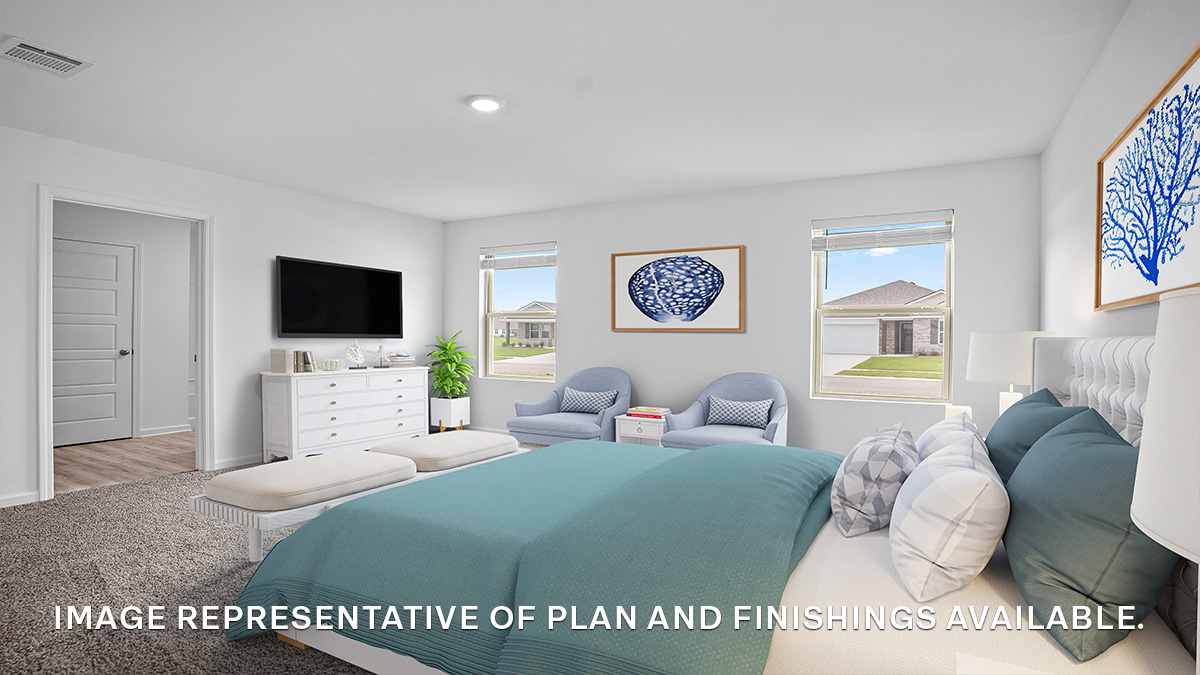 Large primary bedroom with dual windows overlooking the backyard