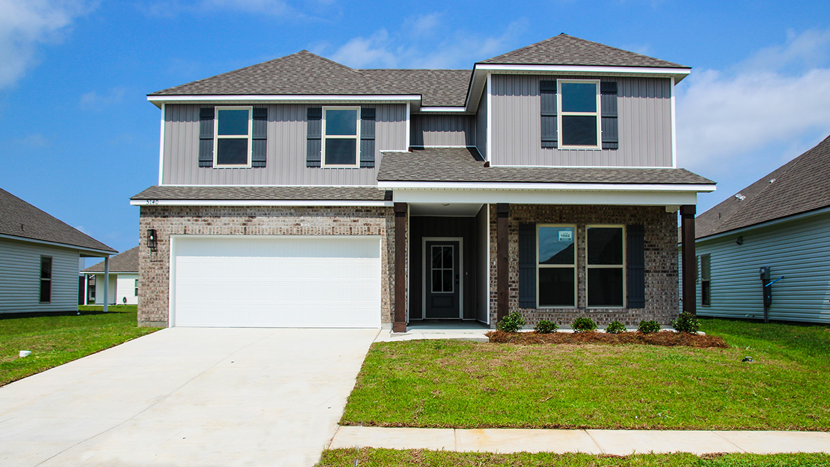 dual-story home with brown brick and gray vinyl with gray front door and shutters