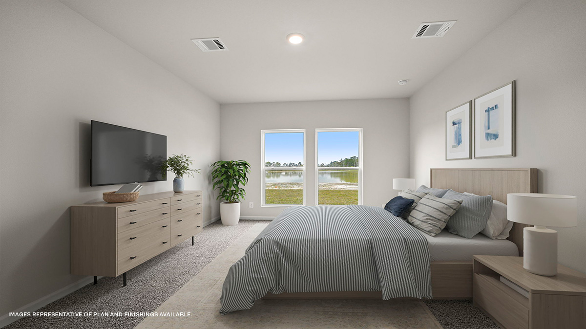 Primary bedroom with dual windows overlooking the backyard
