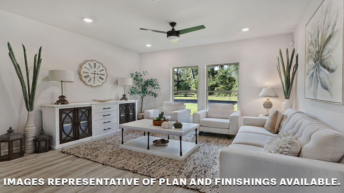 Open-concept living room with dual windows facing backyard