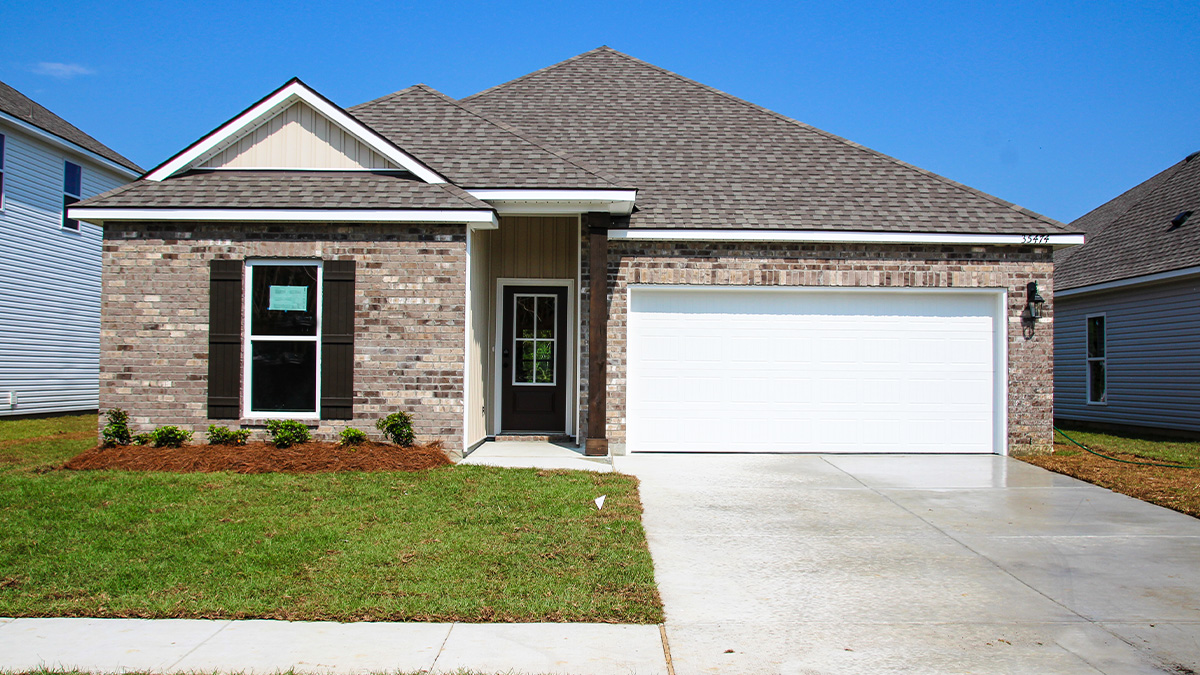 single-story home with brown brick and white vinyl siding with brown front door and shutters with two-car garage