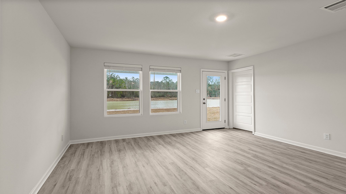 spacious living room with single side-view window with kitchen and dining space in the rear