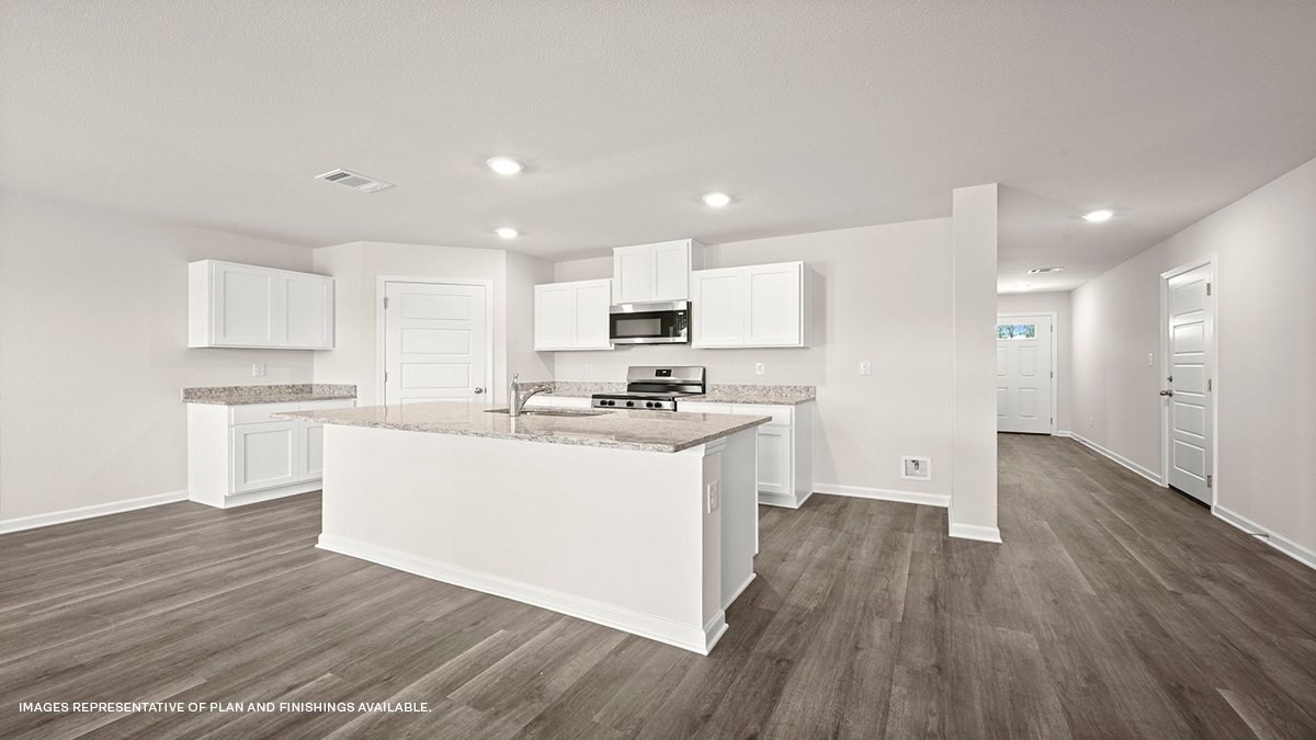 White kitchen island with stools and stainless-steel appliances with foyer and pantry