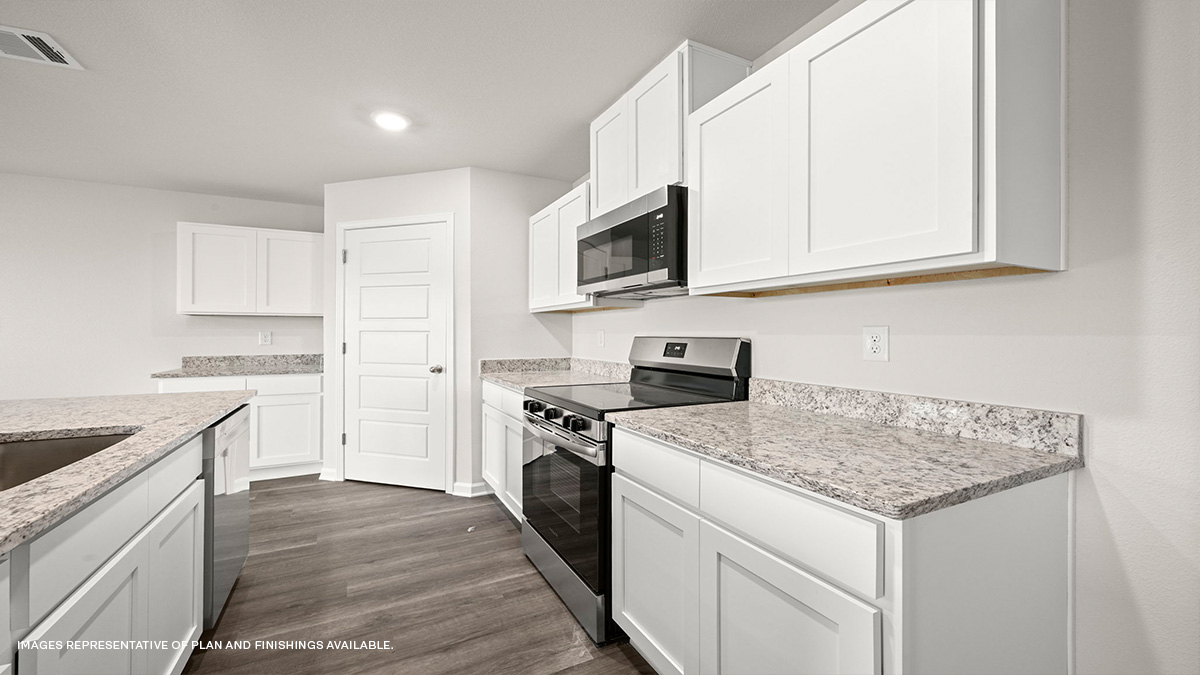 White kitchen cabinets with stainless steel appliances and pantry access