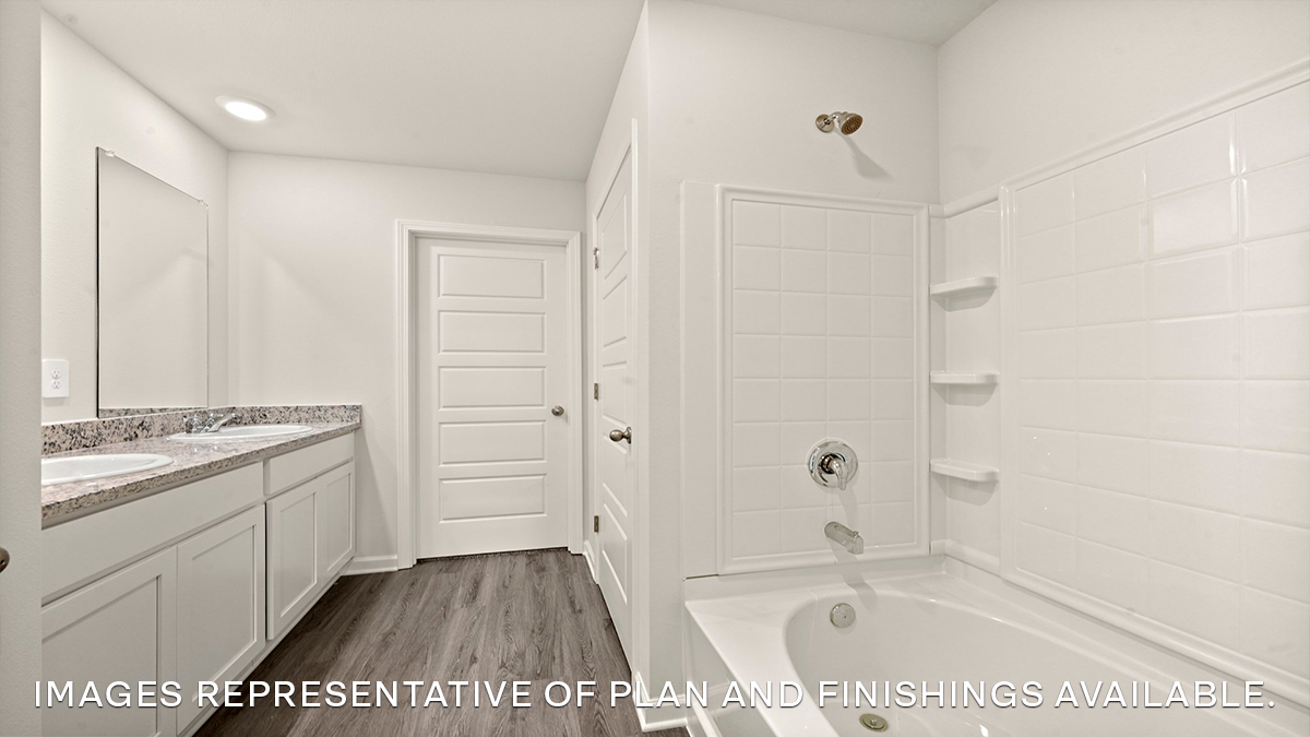 white dual vanities in primary bathroom and shower tub combo