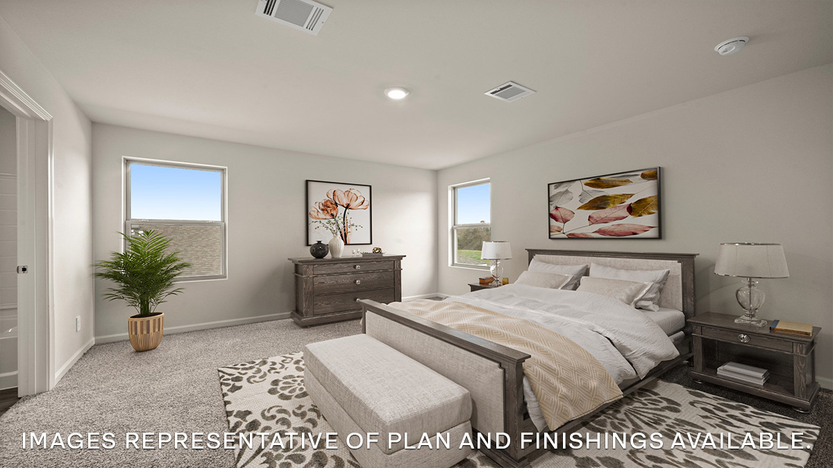 primary bedroom upstairs with multiple windows overlooking yard