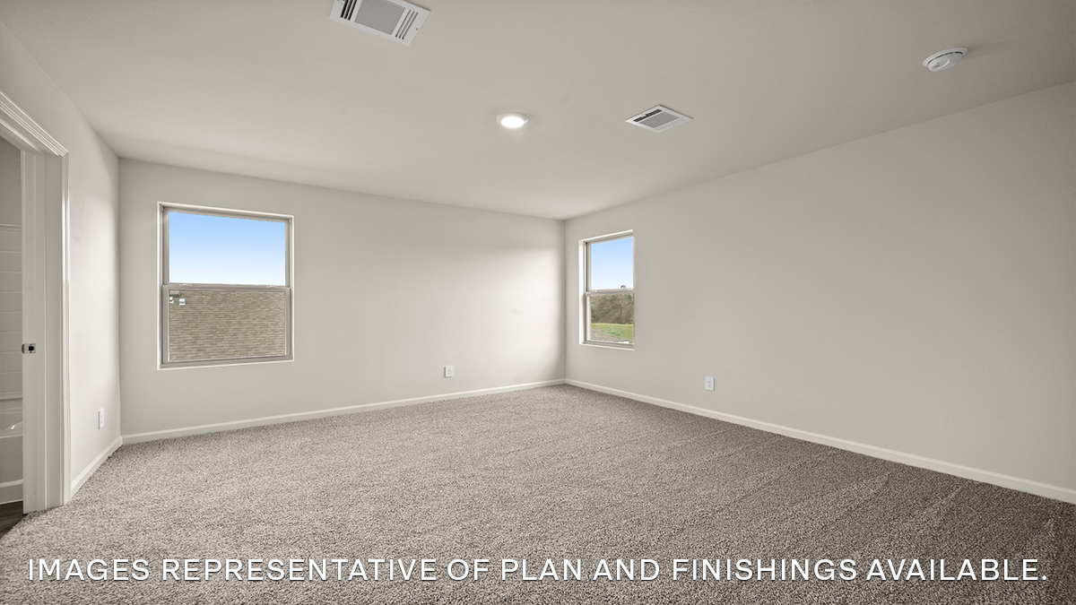 primary bedroom upstairs with multiple windows overlooking yard