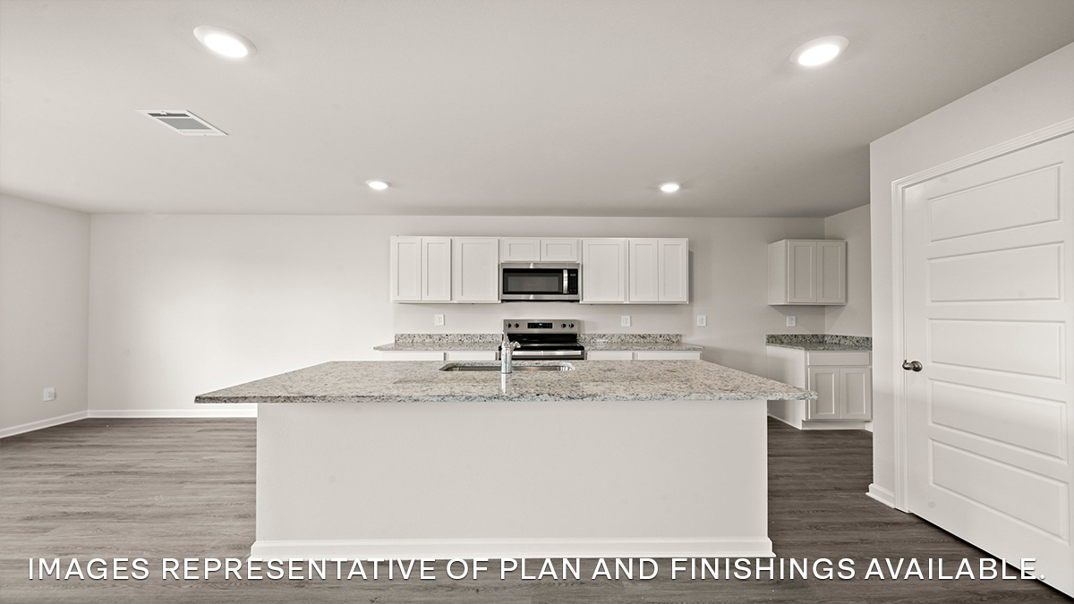 white kitchen island with stainless steel appliances and pantry access