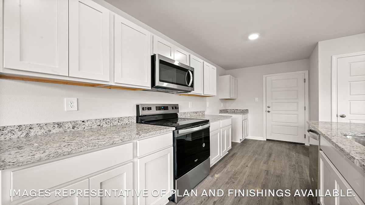 white kitchen island with stainless steel appliances and pantry access