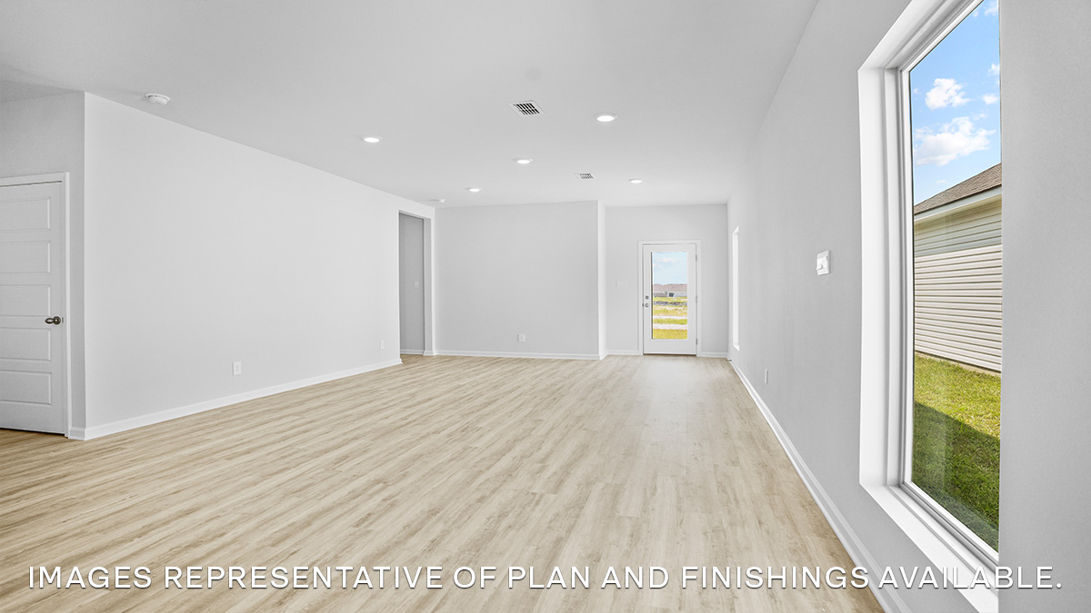 Open-concept living room and dining room with access to backyard