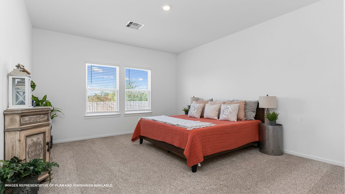 primary bedroom upstairs with multiple windows overlooking yard